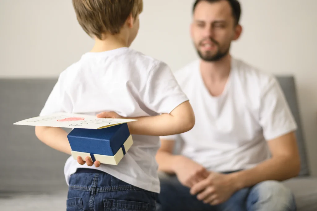 Young boy hiding gift behind back while facing father in child support context