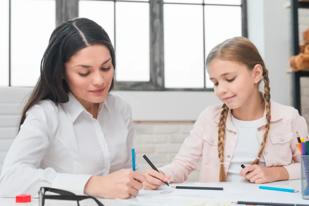 Child support attorney helping young girl complete paperwork at desk