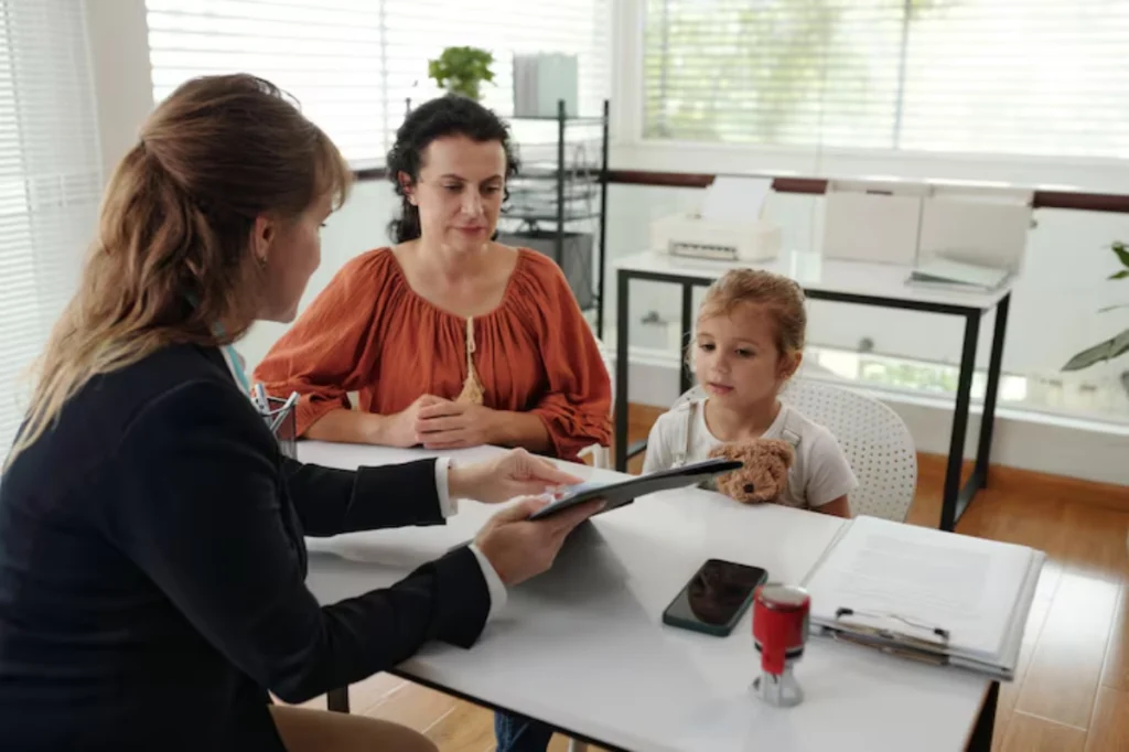 Child support attorney reviewing paperwork with mother and daughter