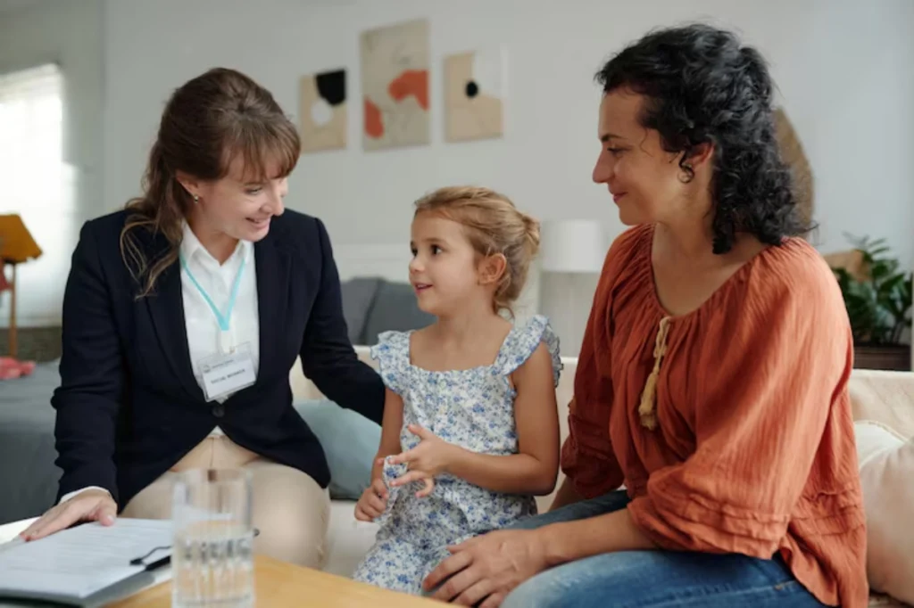 Attorney sitting with mother and young girl during meeting