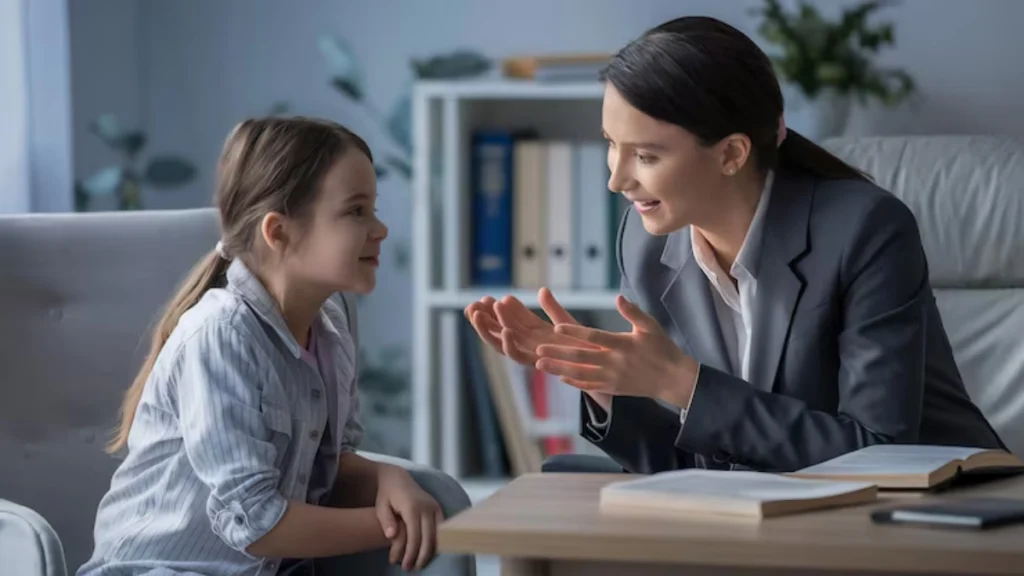 Child support attorney speaking with young girl at office desk