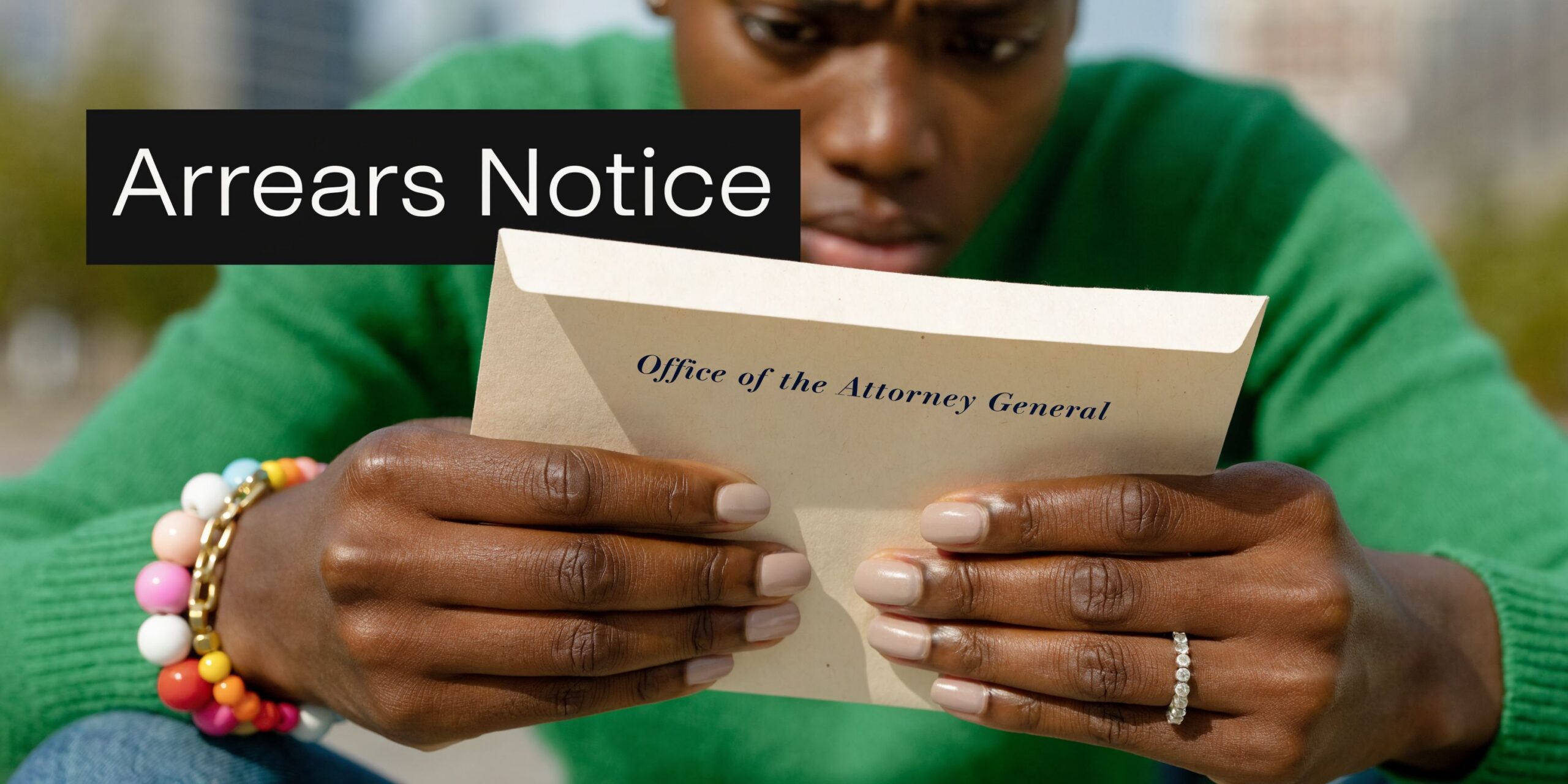 A concerned woman in a green sweater opens an official document from the Office of the Attorney General.
